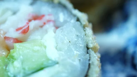 Sushi Macro roll no stick. Uramaki Japanese Rice Salmon Vasabi Tuna soy close-up Vídeos de archivo 128975768