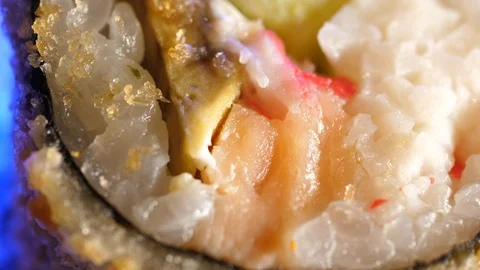 Sushi Macro roll no stick. Uramaki Japanese Rice Salmon Vasabi Tuna soy close-up Stock Footage 128976590
