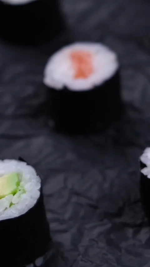 Sushi maki rolls on rotating black background ,fashion food background Stock Footage 309467332