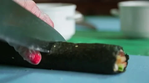 Sushi master cuts finished rolls Stock Footage 61384416