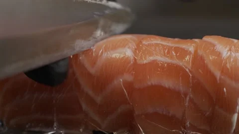 The sushi master cuts the rolled finished roll into small pieces. Cooking sushi. Video stock 145343330