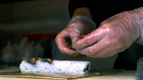 Sushi master decorates rolls with eel Stock Footage 229201045