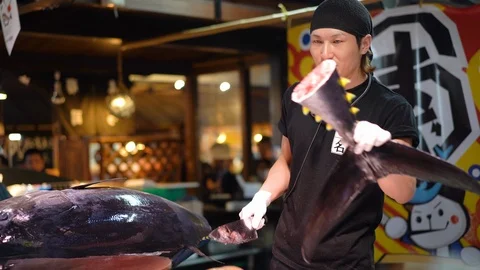 Sushi master is demonstrating during tuna cutting session at Marina City Stock Footage 99629572