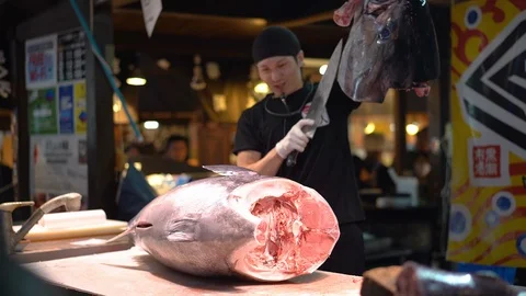 Sushi master is demonstrating during tuna cutting session at Marina City Stock Footage 99629704