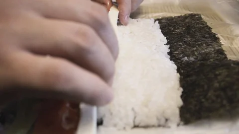 Sushi master makes the roll in the restaurant, and street food. Video stock 129291702