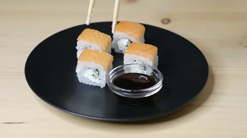 Sushi with red fish. Woman eating Philadelphia sushi. Stock Footage 166457053