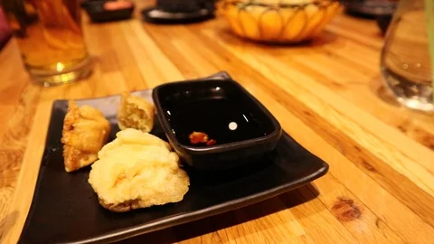 Sushi Restaurant Adding Wasabi to Soy Sauce on Live Edge Table Stock Footage 126986001