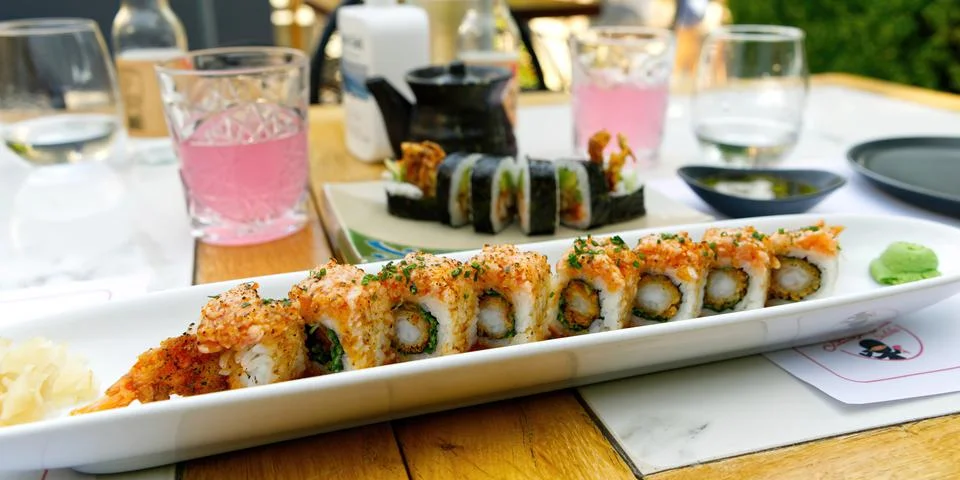 Sushi restaurant. Outside table set up and dish presentation. Raw salmon sushi Stock Photos