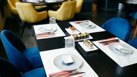 Sushi restaurant table set with assorted sushi rolls Stock Photos
