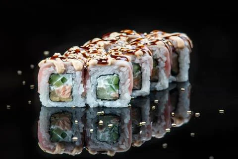 Sushi Roll On A Black Background reflection . Japanese food. Close Up. Stock Photos