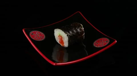Sushi roll on black plate rotating Stock Footage 55640967