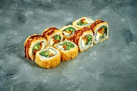 Sushi roll with breaded eel, cucumber on a gray background. Selective Focus.  Foto stock