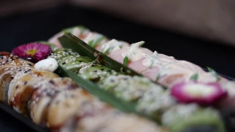 Sushi roll close-up in a box, slow mo wasabi and soy sauce, delicious food deliv Stock Footage 127519323