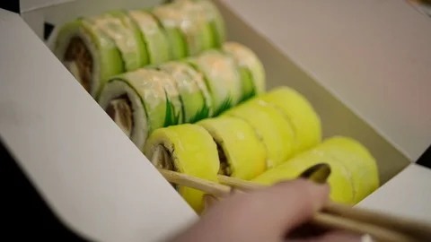 Sushi roll close-up in a box, slow mo wasabi and soy sauce, delicious food deliv Stock Footage 127520542
