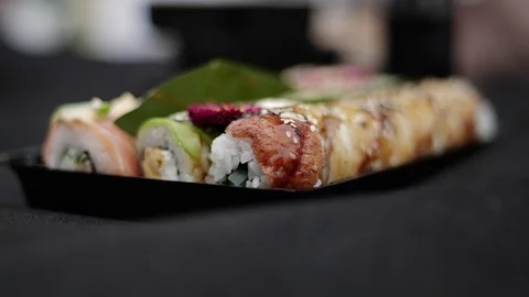 Sushi roll close-up in a box, slow mo wasabi and soy sauce, delicious food deliv Stock Footage 127520951