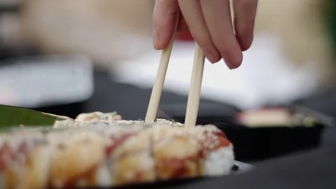 Sushi roll close-up in a box, slow mo wasabi and soy sauce, delicious food deliv Stock Footage 127521543
