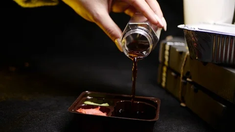 Sushi roll close-up in a box, slow mo wasabi and soy sauce, delicious food deliv Stock Footage 127532495