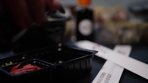 Sushi roll close-up in a box, slow mo wasabi and soy sauce, delicious food deliv Stock Footage 127541644
