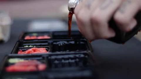 Sushi roll close-up in a box, slow mo wasabi and soy sauce, delicious food deliv Stock Footage 127541694