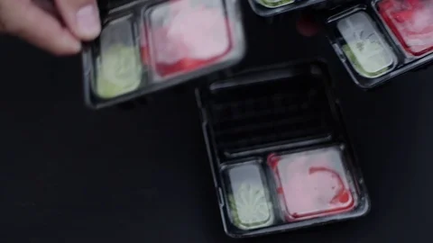 Sushi roll close-up in a box, slow mo wasabi and soy sauce, delicious food deliv Stock Footage 127541700