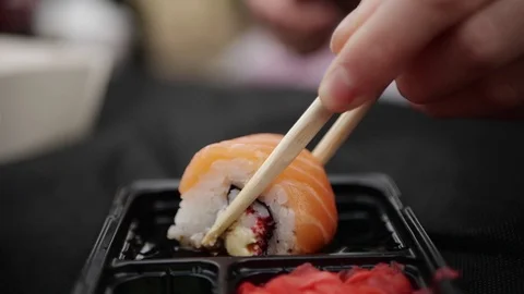 Sushi roll close-up in a box, slow mo wasabi and soy sauce, delicious food deliv Stock Footage 127541791