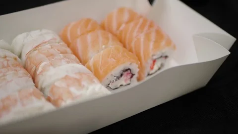 Sushi roll close-up in a box, slow mo wasabi and soy sauce, delicious food deliv Stock Footage 127541799