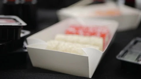 Sushi roll close-up in a box, slow mo wasabi and soy sauce, delicious food deliv Stock Footage 127541811