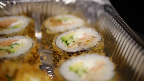 Sushi roll close-up in a box, slow mo wasabi and soy sauce, delicious food deliv Stock Footage 127541931