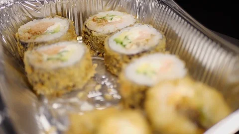 Sushi roll close-up in a box, slow mo wasabi and soy sauce, delicious food deliv Video stock 127541932