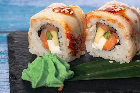 Sushi roll with eel and avocado, caviar, Philadelphia cheese, unagi sauce and Stock Photos