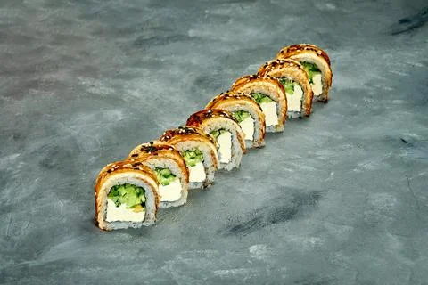 Sushi roll with eel, cucumber and cream cheese on a gray background. Selectiv Stock Photos