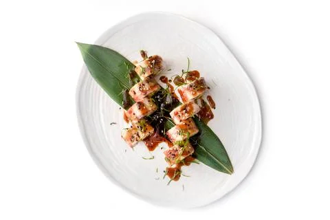 Sushi roll with eel on white plate on white concrete background Stock Photos