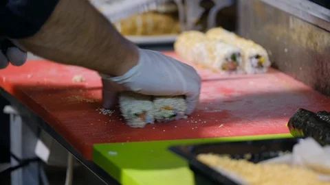 Sushi roll making preparation, close up on chef hands with a knife. Stock Footage 100035922