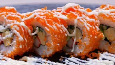 Sushi Roll with Orange Roe, Crab, Avocado, Seafood Rice and Creamy Sauce 스톡 동영상 346307356