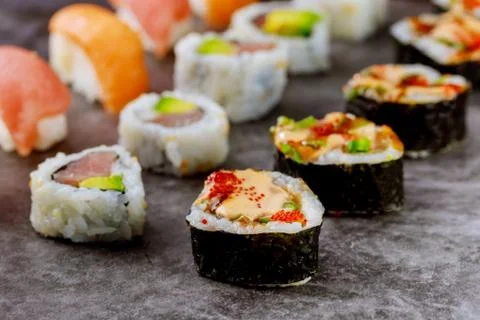Sushi roll with raw fish on gray background. Japanese food. Stock Photos