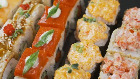 Sushi roll rotated on black background. Sushi japanese food in restaurant. Japan Stock Footage 99385566
