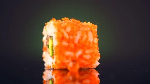 Sushi roll rotated over black background. Sushi roll with tuna, vegetables Stock-Footage 85609136