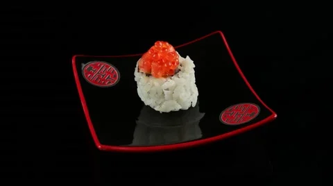 Sushi roll with salmon and caviar on black plate rotating Stock Footage 55638751