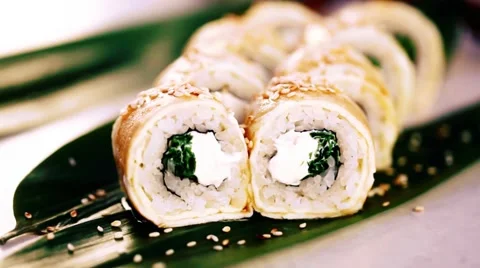 Sushi roll with scrambled eggs sprinkled with sesame seeds Food Movement sesame Stock Footage 62191786