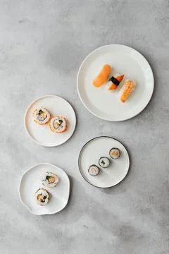 Sushi roll set with salmon, eel, cucumber and cream cheese on gray background Stock Photos
