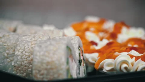 Sushi Roll is Spinning in a Black Container Close-up Vídeo Stock 229532292