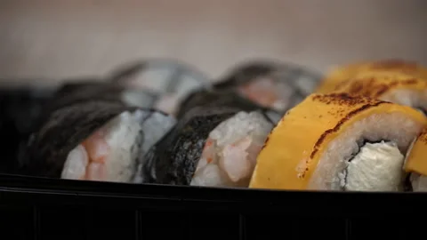Sushi Roll is Spinning in a Black Container Close-up Stock Footage 229532603