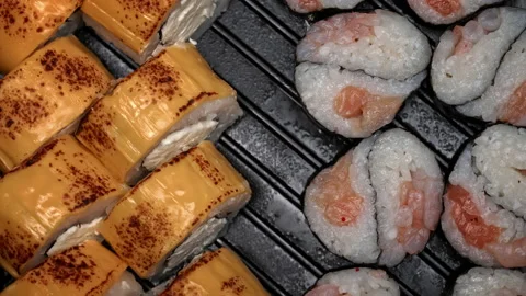 Sushi Roll is Spinning in a Black Container Close-up Stock Footage 229533476