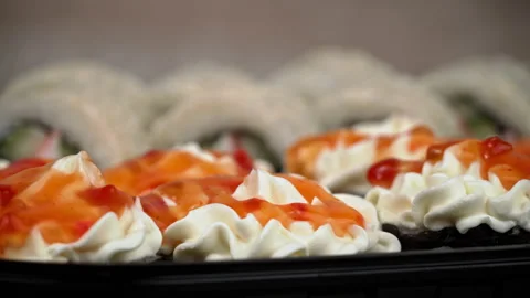 Sushi Roll is Spinning in a Black Container Close-up Stock Footage 236690627