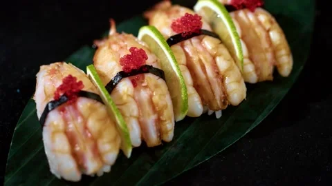 Sushi roll is spinning in a black container close-up. Video stock 239101436