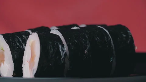 Sushi Roll Turned on a Red Background. Stock Footage 168352154