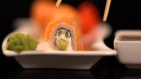 Sushi roll with wasabi dipped in soya sauce Stock-Footage 96336830