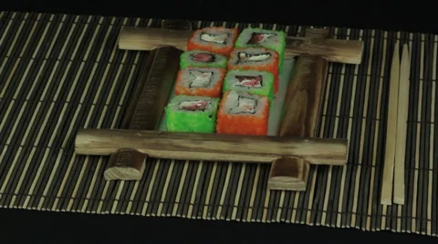 Sushi roll on wooden frame loop Stock Footage 34964046