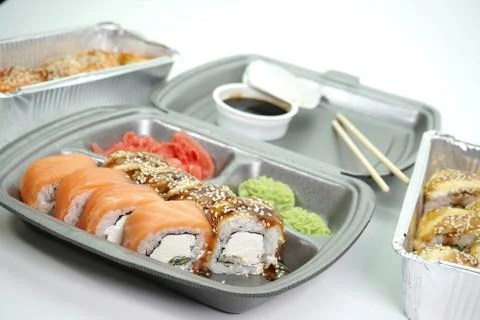 Sushi rolls are Packed in plastic packaging close-up on an isolated background Stock Photos