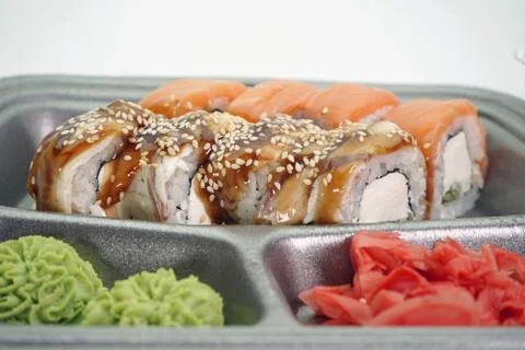 Sushi rolls are Packed in plastic packaging close-up on an isolated background Stock Photos